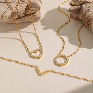 Three 18K gold plated heart and geometric pendant necklaces with sparkling crystals