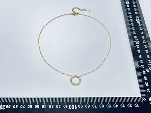 Detail of 18K gold plated heart pendant necklace with measurements on scale