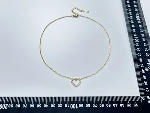 Macro shot of 18K gold plated S925 silver heart necklace with measurements and lobster clasp