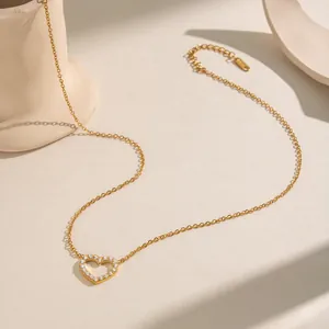 Detailed macro view of 18K gold plated heart pendant necklace with shimmering zircon accents