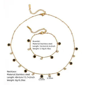 Detailed view of stainless steel necklace and bracelet set with black disc pendants.
