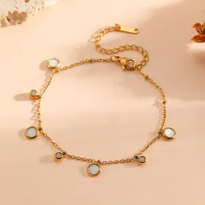 Detailed view of the gold-plated stainless steel chain with shell and crystal pendants.