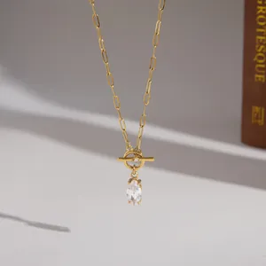 Macro view of gold-plated titanium steel necklace with marquise zircon pendant and OT clasp.