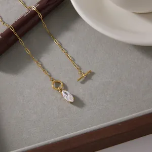 Detailed view of gold stainless steel necklace with marquise zircon pendant and T-bar clasp.