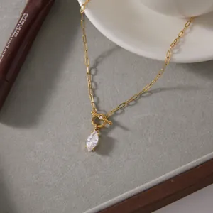 Close-up of gold paperclip necklace with toggle clasp and marquise zircon pendant
