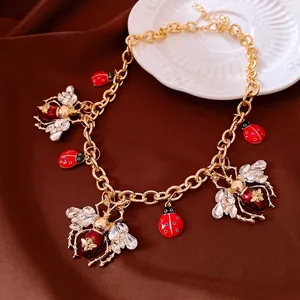 Vintage gold chain necklace with rhinestone bee and enamel ladybug charms for women