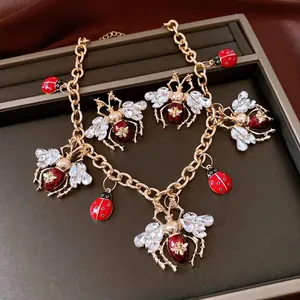 Vintage insect jewelry set with bee and ladybug charms, rhinestones, and red enamel