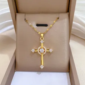 Luxurious gold cross necklace with sparkling zircon stones on a silk background