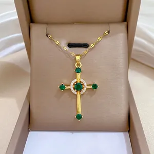 Elegant gold titanium cross necklace with green zircon gems and micro-pave crystals