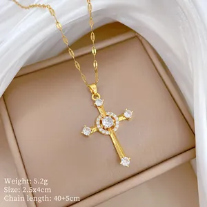 Close-up of gold cross pendant with cubic zirconia stones and 40cm plus 5cm chain details