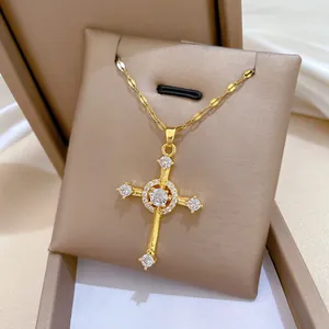Macro detail of gold cross necklace with sparkling zircon inlay in a jewelry box