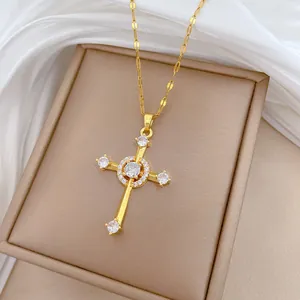 Macro shot of gold-plated cross pendant with clear zircons on beige leather display