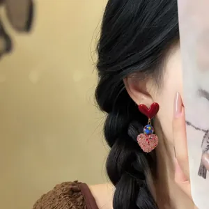 Detailed view of sweet resin heart drop earrings featuring red and pink heart accents