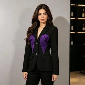 Detailed close-up of purple heart-shaped satin patchwork on black tailored suit jacket