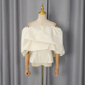 Elegant off-shoulder cream corset top with voluminous pleated ruffles and fitted waist