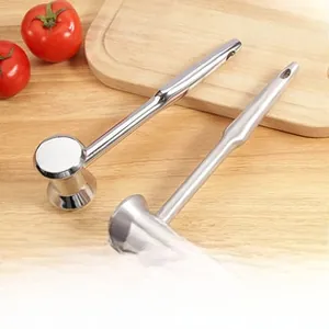 Close-up of stainless steel meat mallet set with spiked and flat heads on wooden board