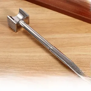 Detail of metal meat tenderizer hammer with textured teeth and built-in hanging hook