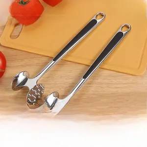 Dual zinc alloy meat mallets with non-slip handles on a wooden kitchen countertop