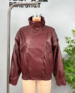 Close-up of wine red faux leather jacket with high collar and litchi texture finish