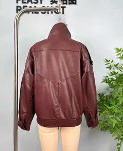 Detail view of the back of a deep red faux leather jacket with V-shaped geometric stitching