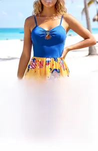 Detail of blue bodice with crown metal buckle and sea creature print on yellow skirt