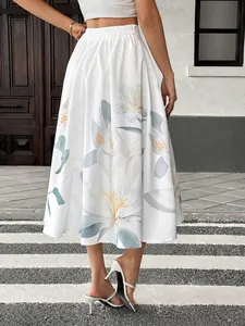 Detail of high-waisted white midi skirt with large floral lily print on lightweight fabric