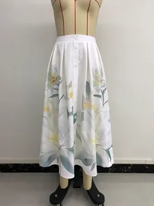 Detail of high-waisted A-line skirt with yellow lily print and front button closure