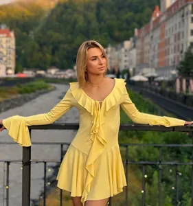 Detail of elegant tiered ruffles and tie neck on yellow slim fit flare sleeve dress