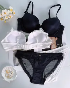 Detailed flat lay of seamless lingerie set with gold pendants and mesh panty panels
