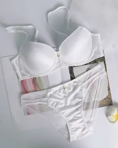 White satin push up lingerie set with lace mesh stitching and gold pendant details