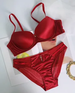Detail view of red seamless satin lingerie set with mesh fabric and heart charms
