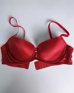 Elegant red seamless push-up bra with smooth satin finish and decorative center pendant