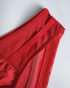 Detail of red seamless bra showing breathable mesh texture and satin finish with trim