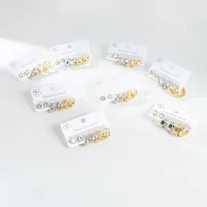 Three pairs of stainless steel hoop earrings in gold and silver with various textures