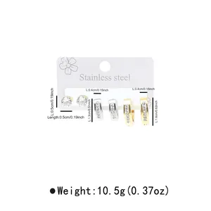 Detail view of gold and silver stainless steel earrings set with sparkling rhinestones