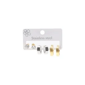 Detailed view of three-pair stainless steel earring set with gold and silver hoops and studs