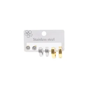 Three-pair set of stainless steel stud earrings and textured metal hoop earrings in silver and gold