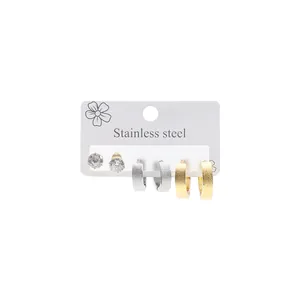 Detail of three-pair stainless steel earring set featuring studs and textured hoops