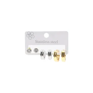 Detailed view of stainless steel earring set including silver and gold hoops and zircon studs