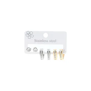 Three pairs of stainless steel earrings with studs and crystal-set hoop details