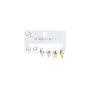 Detailed view of stainless steel earring set with zircon studs and diamond hoops