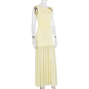Close-up of cream sleeveless dress featuring a gold metal buckle on the knotted shoulder
