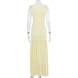 Back view of light yellow sleeveless dress with pleated mesh fishtail hem detail