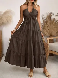 Detail of tiered bohemian halter maxi dress with backless design and chocolate brown fabric