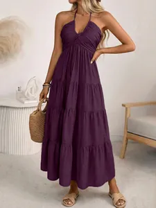 Detail of dark purple tiered halter maxi dress with backless design and relaxed fit