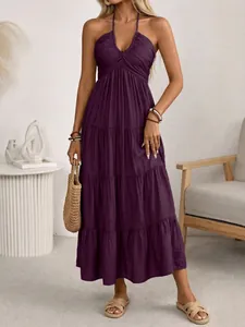 Detail of deep purple halter neck maxi dress with pleated bodice and tiered ruffle skirt