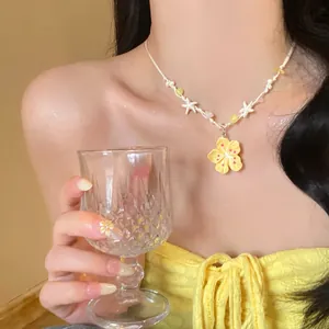 Detail of yellow flower beaded necklace with starfish charms for summer vacation