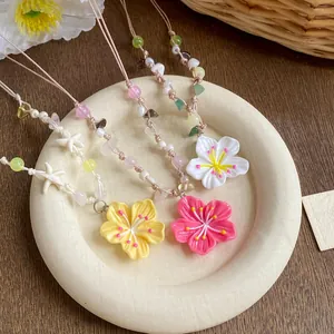 Macro view of colorful dopamine style beaded necklaces with flower and starfish charms