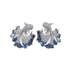 Elegant sparkly zircon fish stud earrings with ornate blue and white gemstone inlay