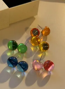 Detail shot of vibrant translucent dopamine colorful ball stud earrings for a summer look